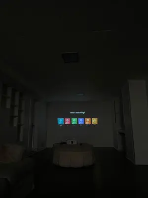 a dark room with a table in front of a tv at Home in West Vancouver in West Vancouver