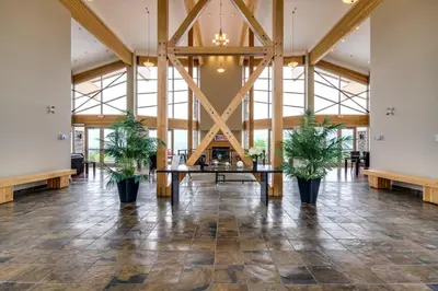 a large lobby with a table and potted plants at Top Floor Lakeview Condo at Copper Sky 509 in West Kelowna