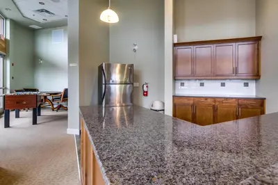 a kitchen with a granite counter top and a dining room at Top Floor Lakeview Condo at Copper Sky 509 in West Kelowna
