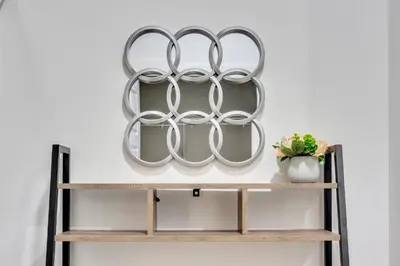 a shelf with three metal rings on a wall at Your Happy Place Seton3 bed. Sleeps 6. 2.5bath in Calgary