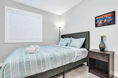 a bedroom with a bed and a window at Your Happy Place Seton3 bed. Sleeps 6. 2.5bath in Calgary
