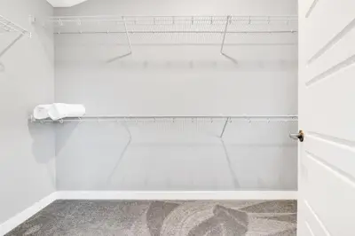 a bathroom with white walls and a shower stall at Your Happy Place Seton3 bed. Sleeps 6. 2.5bath in Calgary
