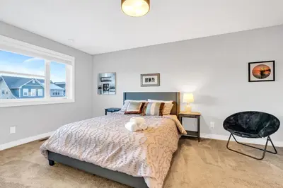 a bedroom with a bed and a window at Your Happy Place Seton3 bed. Sleeps 6. 2.5bath in Calgary