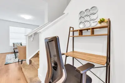 a living room with a chair and a table at Your Happy Place Seton3 bed. Sleeps 6. 2.5bath in Calgary