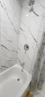 a white bathroom with a sink and a mirror at Cozy One bedroom BSMT Apartment in Edmonton