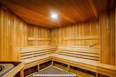 a sauna with wood paneled walls and a ceiling at Luxury 2-bedroom condo beach side Yaletown in Vancouver