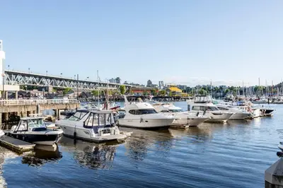 a bunch of boats are docked in a harbor at Luxury 2-bedroom condo beach side Yaletown in Vancouver