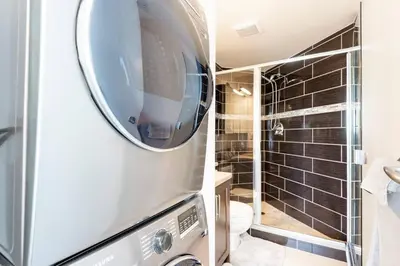 a bathroom with a toilet and a walk in shower at Luxury 2-bedroom condo beach side Yaletown in Vancouver