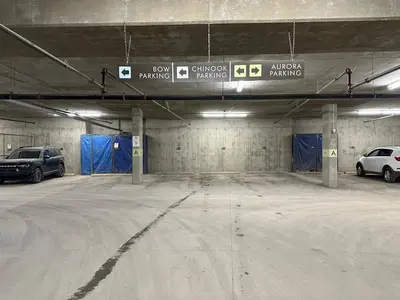 a parking garage with two cars parked in it at Mountain Retreat Corner Suite -Pool - Hot Tub & Spa Escape in Canmore
