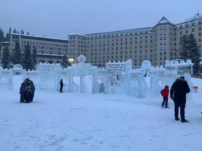 a group of people standing in front of an ice sculpture at Mountain Retreat Corner Suite -Pool - Hot Tub & Spa Escape in Canmore