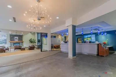 a lobby of a hospital with a chandelier at Mountain Retreat Corner Suite -Pool - Hot Tub & Spa Escape in Canmore