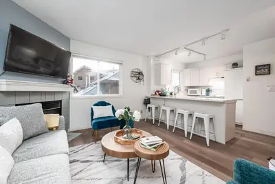 a living room with a couch and a table at Luxurious Retreat/Hot Tub/Mountain View/4 Beds in Canmore