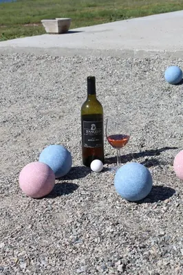 a bottle of wine and a glass on the ground at D'Angelo Winery Farm House in Penticton