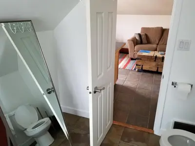 a bathroom with a toilet and a living room at Bon Homme View in Jasper