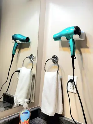 a blow dryer is plugged into a bathroom mirror at Spacious 2BR Near HWY 1-Heritage Park - Cultus Lake -Fishing! in Chilliwack