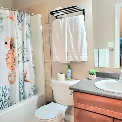 a bathroom with a toilet and a sink at Spacious 2BR Near HWY 1-Heritage Park - Cultus Lake -Fishing! in Chilliwack