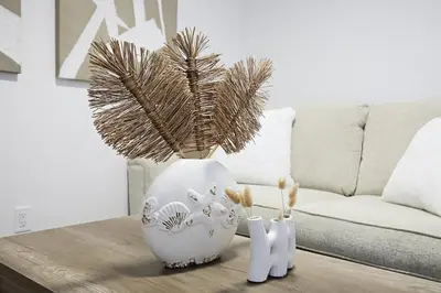 a white vase with a plant in it on a table at BoHo Retreat with King Beds, Golf, Disney+, Near WEM in Edmonton