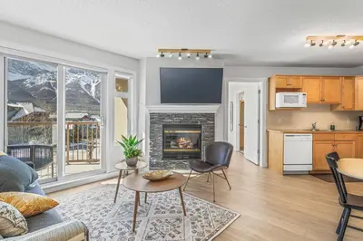a living room with a couch and a fireplace at W411 NEW- TOP of the World Canmore MTN Retreat in Canmore
