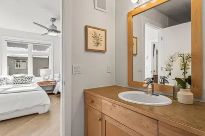 a bathroom with a sink and a bed and a mirror at W411 NEW- TOP of the World Canmore MTN Retreat in Canmore