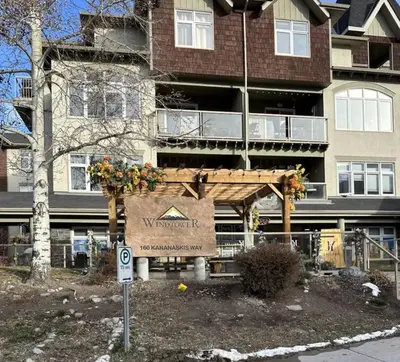 a sign in front of a large building at W411 NEW- TOP of the World Canmore MTN Retreat in Canmore