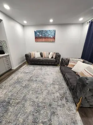 a living room with a couch and a rug at Cozy one bedroom in Airdrie in Airdrie