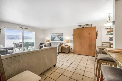 a living room with a view of the ocean at The Lakeside Condo #202 in West Kelowna