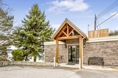 a building with a bench in front of it at The Lakeside Condo #202 in West Kelowna
