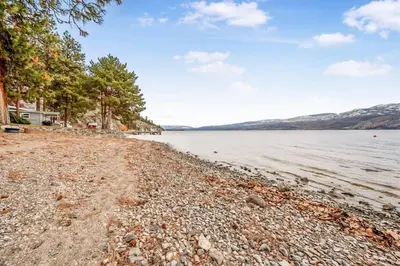 a rocky shore of a body of water at The Lakeside Condo #202 in West Kelowna