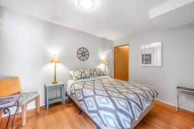 a bedroom with a bed and a desk and a bed sidx sidx sidx at The Lakeside Cabin with wide outside space #105 in West Kelowna