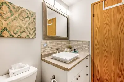 a bathroom with a sink and a mirror at The Lakeside Cabin with wide outside space #105 in West Kelowna