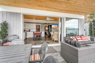 a living room with a couch and chairs on a patio at Lakeside Serenity Retreat #10 in West Kelowna
