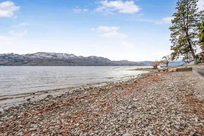 a rocky beach next to a body of water at The Perfect Getaway Cabin in the Okanagan #6 in West Kelowna