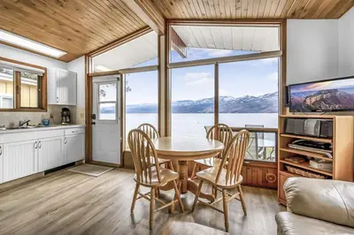 a kitchen and dining room with a table and chairs at Cozy Cottage by the Lakeshore #4 in West Kelowna