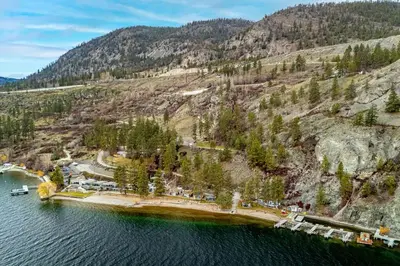 an aerial view of a dock in the water at Cozy Cottage by the Lakeshore #4 in West Kelowna