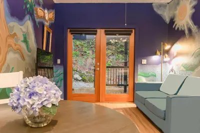 a living room with a couch and a table at Sungate on Salt Spring - Luxurious Suite with Cedar Hot Tub & View in Salt Spring Island