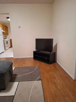 a living room with a flat screen tv in a room at 1-Bedroom Basement Suite in Yellowknife