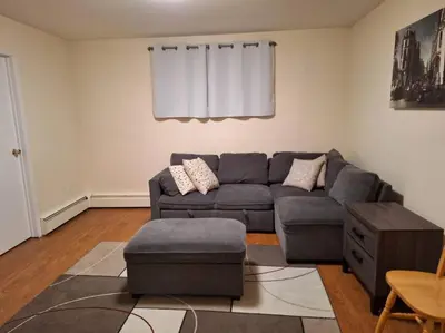 a living room with a couch and a table at 1-Bedroom Basement Suite in Yellowknife
