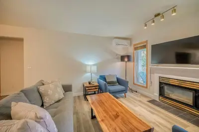 a living room with a couch and a fireplace at Bow Valley Chalets-Entire 2 King Bedrooms townhouse in Canmore