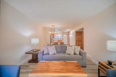 a living room with a blue couch and a table at Bow Valley Chalets-Entire 2 King Bedrooms townhouse in Canmore