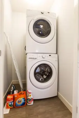 a washing machine and a washer in a room at Modern Home - King Bed - Garage - Long Stays in Edmonton