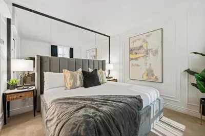 a bedroom with a large bed with a large headboard at Elegant & Luxury 2 Bed Suite Close to Convention Centre in Vancouver