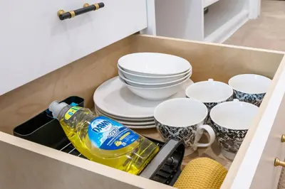 a drawer filled with dishes and a bottle of wine at Elegant & Luxury 2 Bed Suite Close to Convention Centre in Vancouver