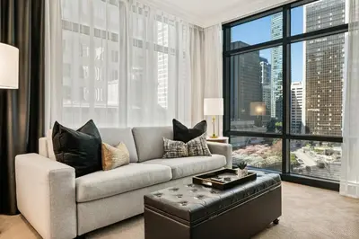 a living room with a couch and a large window at Elegant & Luxury 2 Bed Suite Close to Convention Centre in Vancouver