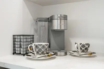 two coffee cups and saucers sitting on a counter at Elegant & Luxury 2 Bed Suite Close to Convention Centre in Vancouver