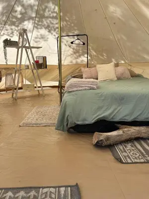 a bedroom with a bed in a tent at #Y2 Sage & Wildflower Yurt in Drumheller