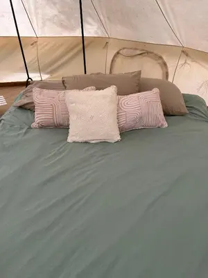two pink pillows on a bed in a tent at #Y2 Sage & Wildflower Yurt in Drumheller