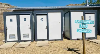 a building with four doors and a sign in front at #Y2 Sage & Wildflower Yurt in Drumheller