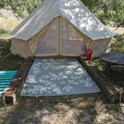 a teepee tent with a table and a bench at #Y4 Aurora Haven Yurt in Drumheller