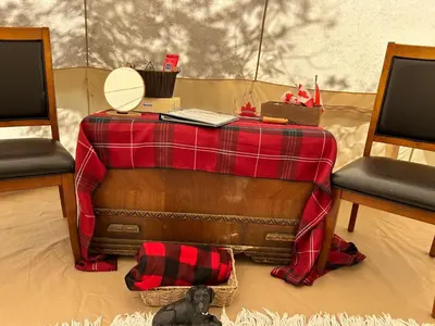 a table with a blanket on top of it with two chairs at #Y5 Lumberjack Lounge Yurt in Drumheller