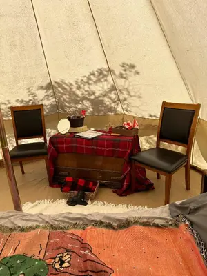 two chairs and a table in a tent at #Y5 Lumberjack Lounge Yurt in Drumheller